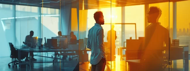 a sleek, modern office space buzzes with energy as a diverse team of professionals engages in lively discussions around high-tech communication devices, symbolizing the dynamic world of telesales outsourcing.